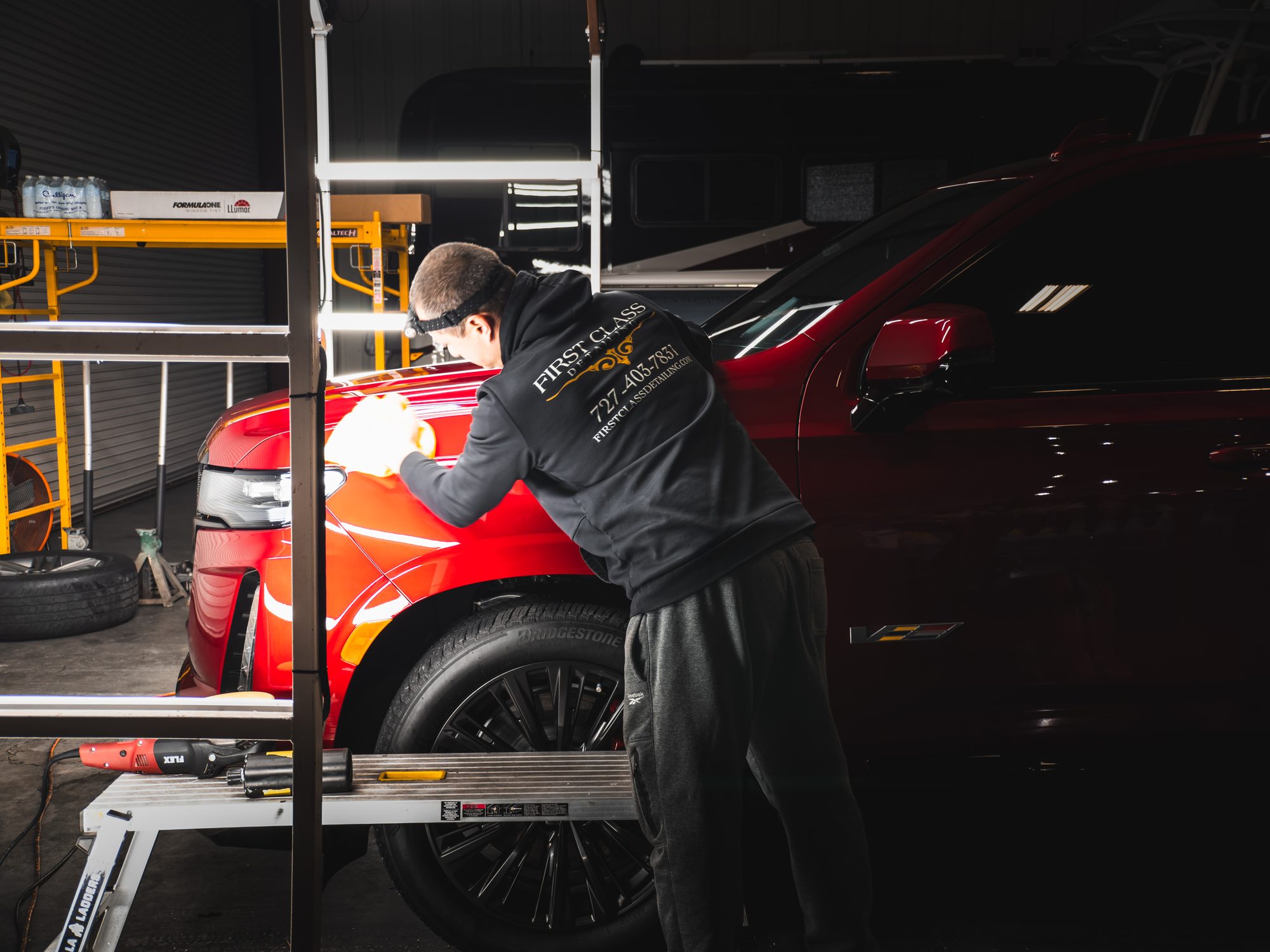 Detailer polishing a Cadillac Escalade-V