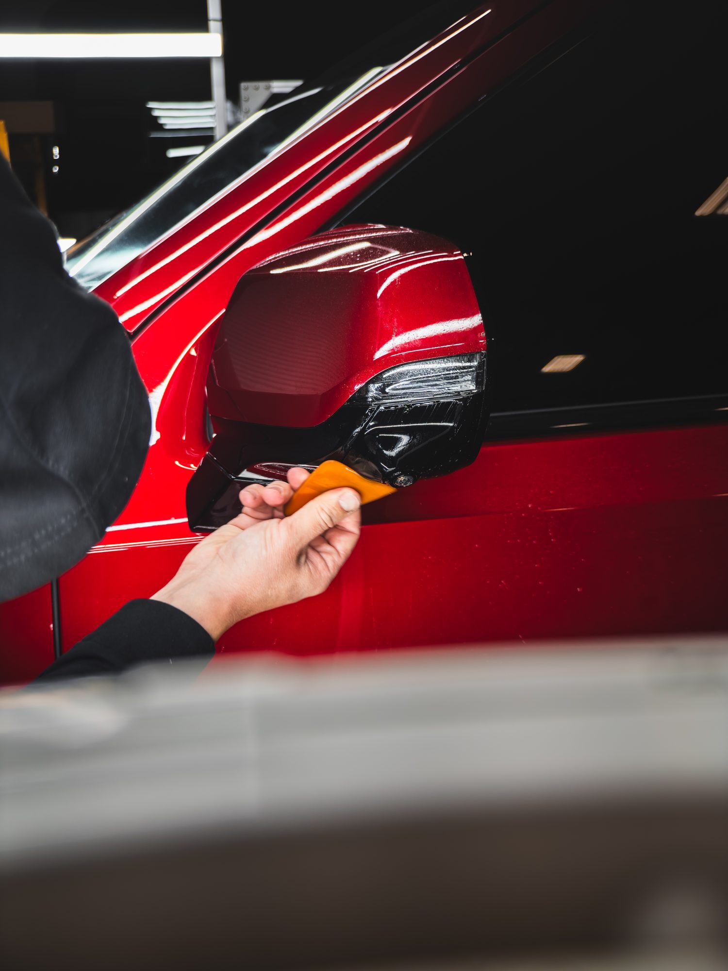 Applying paint protection film to the mirror