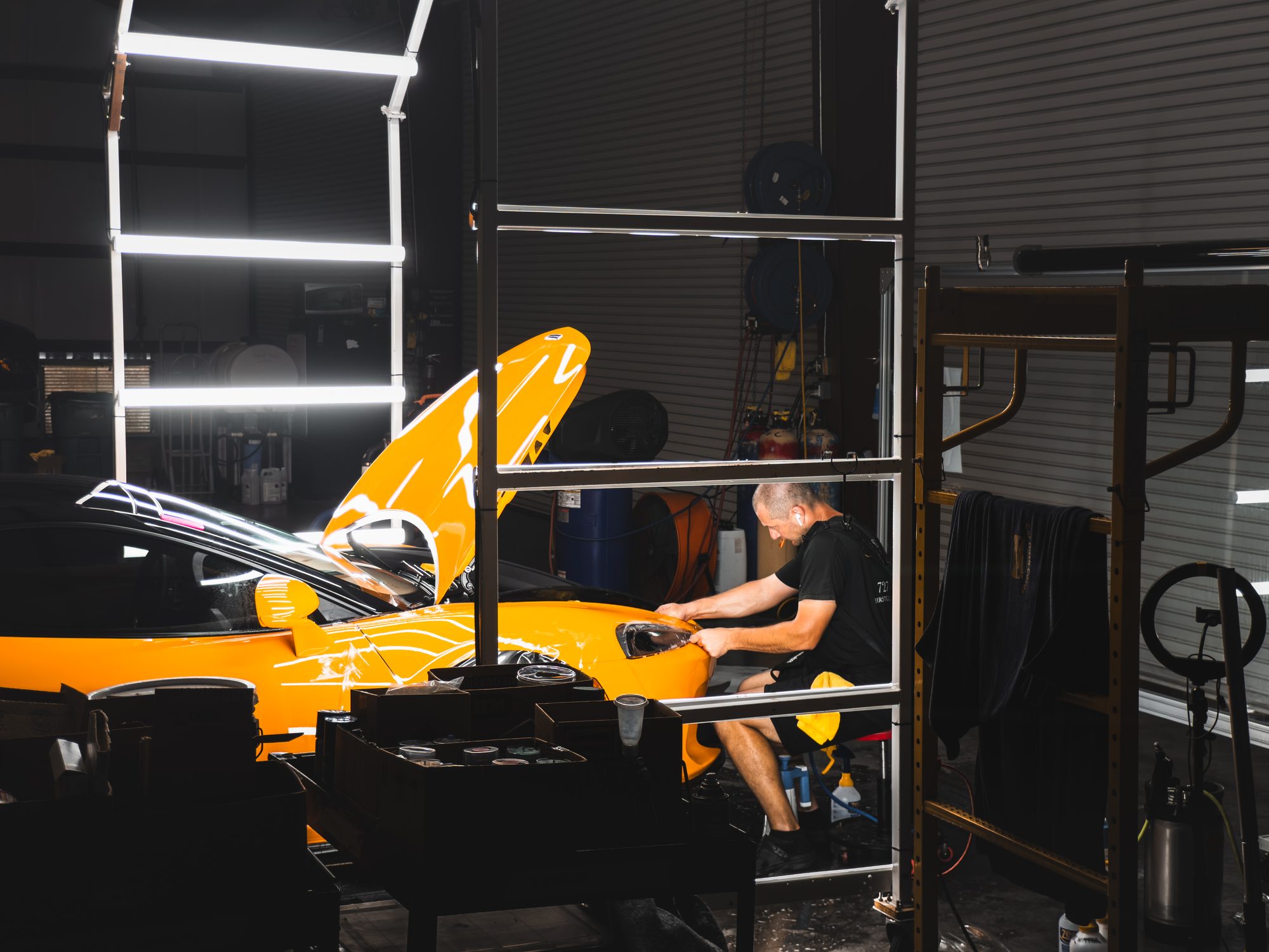 Detailer working on a McLaren GT