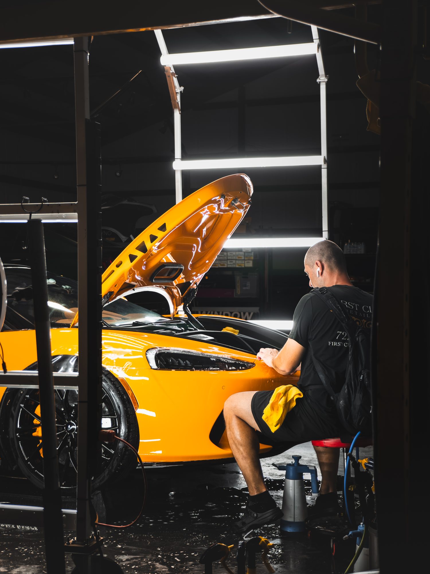 Detailer polishing a McLaren GT