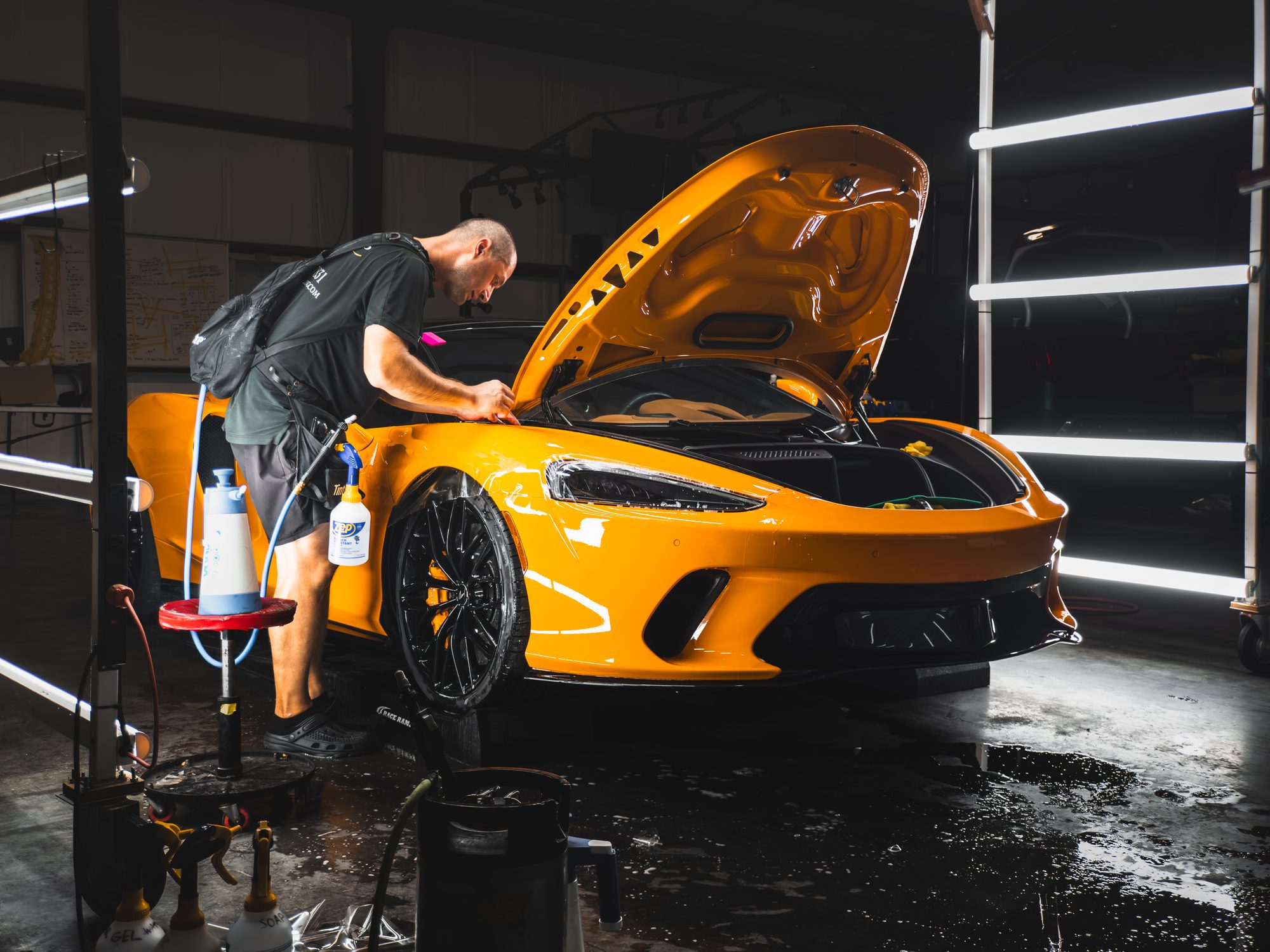 Detailer working on a McLaren GT